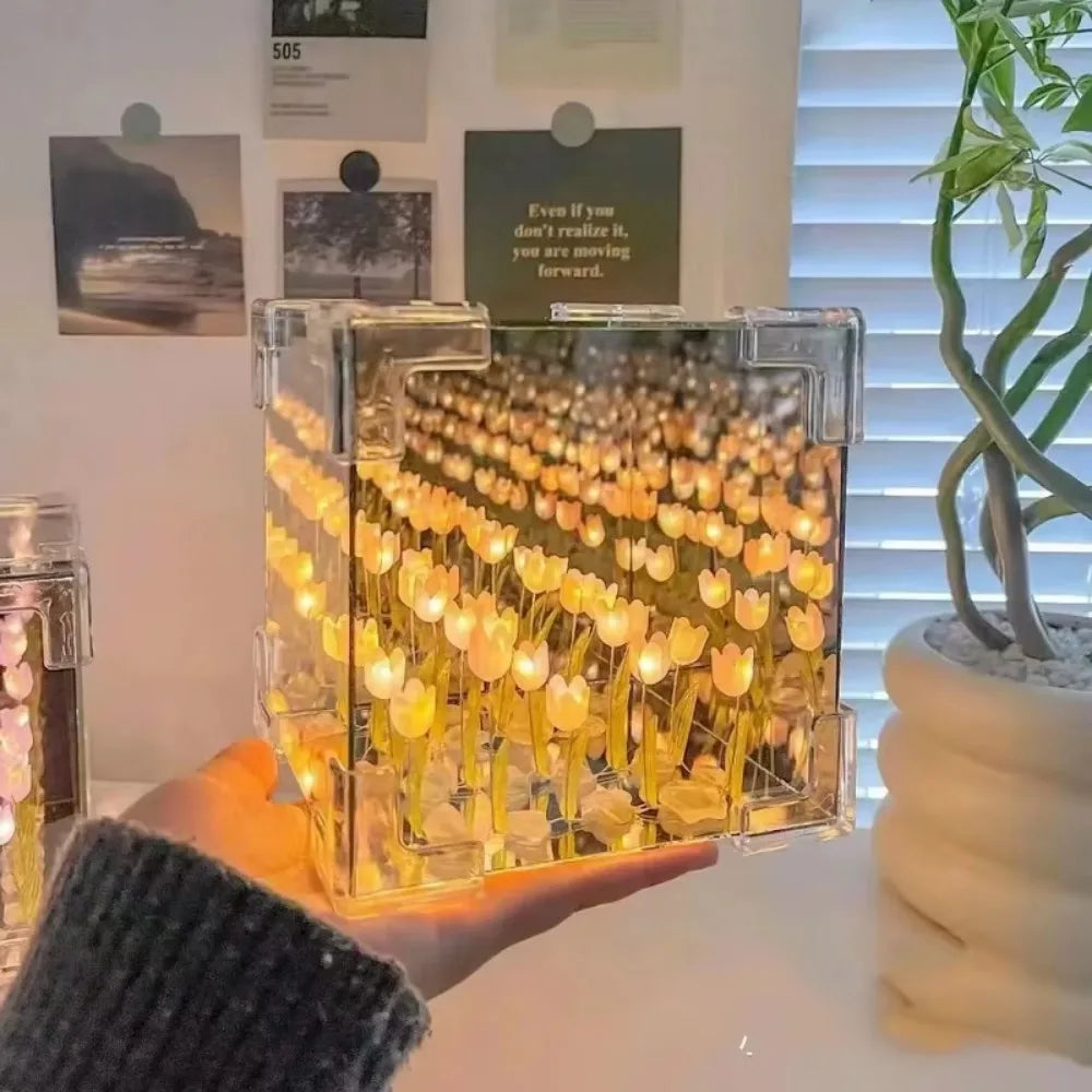 Creative Tulip Flower Sea Cube illuminated display featuring rows of glowing yellow tulip lights enclosed in a transparent cube, creating a mesmerizing 3D light effect against a cozy home setting with window blinds and decorative wall art in the background.