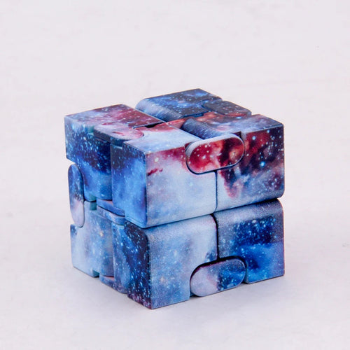 Infinity Magic Cube featuring a mesmerizing galaxy pattern design with swirling blues, purples, and reds on a white background, displayed in its cubic form showing interconnected segments that enable smooth folding and transformation motions.