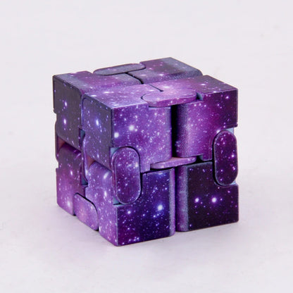 Infinity Magic Cube featuring a mesmerizing galaxy pattern in deep purple and starry design, displaying interconnected segments that create a transformable fidget cube against a light background. Perfect for stress relief and creative manipulation.