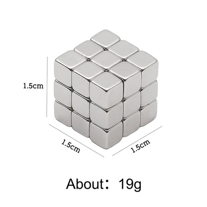 A compact silver magnetic cube measuring 1.5 cm on each side is displayed against a white background. The weight is indicated as approximately 19 grams. The cube is made of small metallic magnetic blocks, showcasing its precise dimensions and portability.